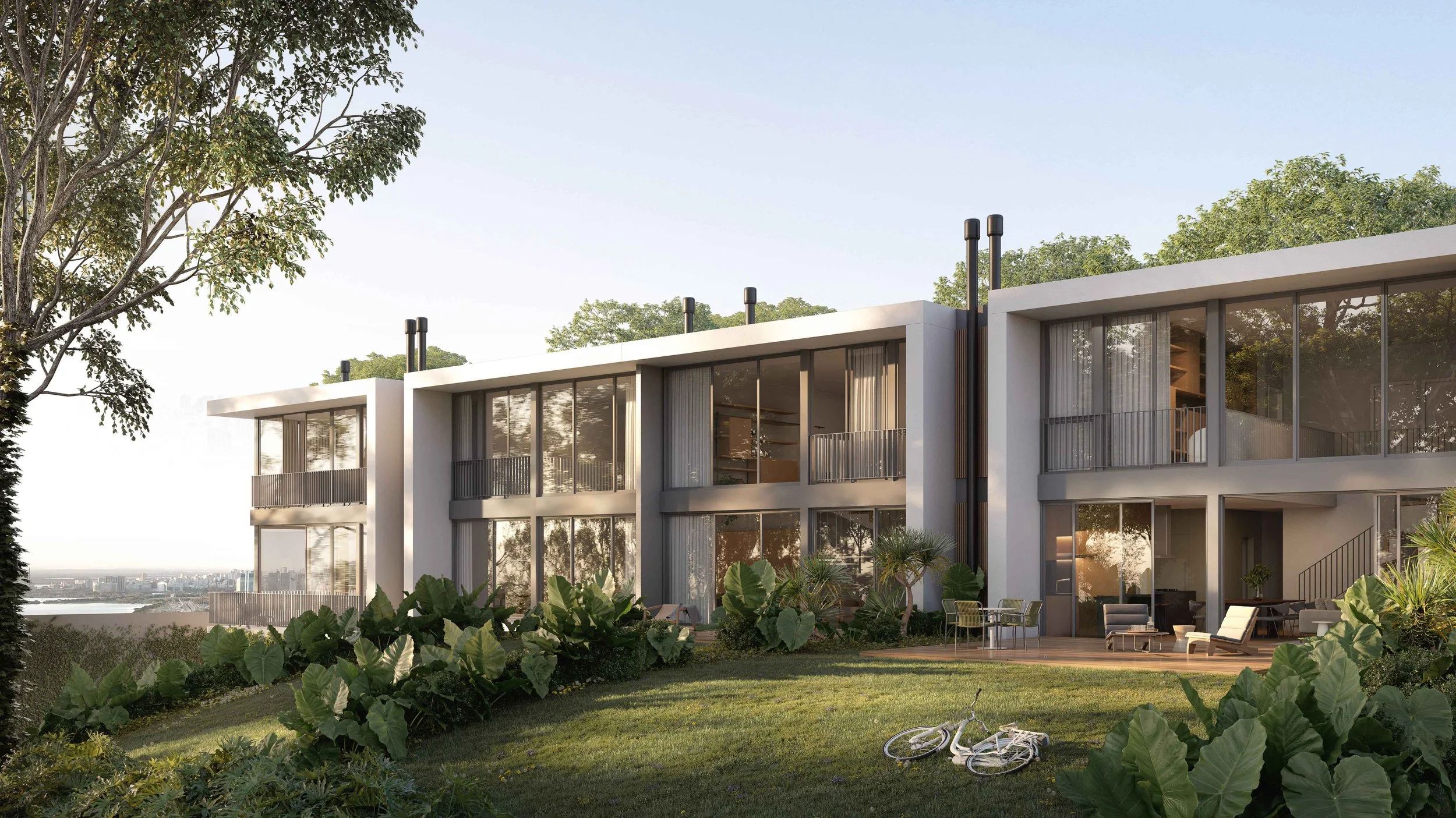 Perspectiva das casas do Aria vistas pelos fundos, com os pátios privativos, gramado e árvores
